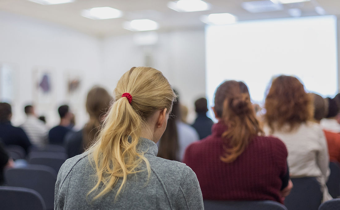 Audience seated during a conference presentation
